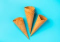 A set of waffle cones for ice cream on a light blue background. Royalty Free Stock Photo