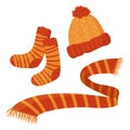 A set of warm autumn clothes - colorful designs for cold weather - an orange woolen hat, striped socks, an orange scarf Royalty Free Stock Photo