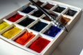 A set of watercolor paints and a brush for drawing on a white table Royalty Free Stock Photo
