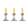 Set of wax candles in metal candlesticks Royalty Free Stock Photo