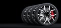 Set of wheels with modern alu rims on black background Royalty Free Stock Photo