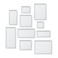 Set of White Blank Picture Frames, hanging on a White Wall from Royalty Free Stock Photo