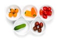 Set of white bowls full of fresh colorful vegetables top view close up