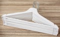 Set of white coat hangers on the wooden background Royalty Free Stock Photo