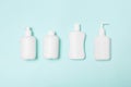 Set of White Cosmetic containers isolated on blue background, top view with copy space. Group of plastic bodycare bottle Royalty Free Stock Photo
