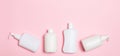 Set of White Cosmetic containers isolated on pink background, top view with copy space. Group of plastic bodycare bottle Royalty Free Stock Photo