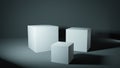 Set of white cubes in a grey lit studio, presentation pedestals.