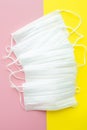 Set of white medical maskon yellow and pink background. Face mask protection against pollution, virus, flu and coronavirus. Royalty Free Stock Photo