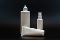 Set of white plastic bottles packages, tubes on black background. For cosmetic product Royalty Free Stock Photo