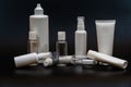 Set of white plastic bottles packages, tubes on black background. For cosmetic product Royalty Free Stock Photo