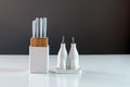 Set of white porcelain vinegar, oil, salt and pepper shakers and kitchen knife set in white holder on the kitchen table, close-up Royalty Free Stock Photo