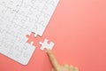 Set of white puzzle pieces and hand holding last one piece Royalty Free Stock Photo