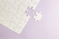 Set of white puzzle pieces and last one piece on purple background Royalty Free Stock Photo