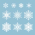 Set of white snowflakes isolated on a blue background. Vector illustration. Royalty Free Stock Photo