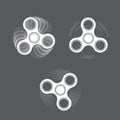 Set of white spinning fidget spinners on gray background Royalty Free Stock Photo