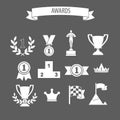 set of white vector award success and victory icons with trophies cups ribbons medals medallions wreath and a podium on grey