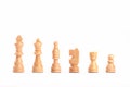 Set of white wooden chess figures in a row isolated on white background Royalty Free Stock Photo