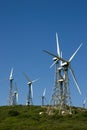 Set of wind power mill towers against blue sky Royalty Free Stock Photo