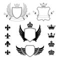 Set of winged shields - coat of arms - heraldic design elements, fleur de lis and royal crowns Royalty Free Stock Photo
