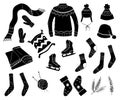 Set of winter clothes, sweater, hat, scarf, skates, socks. Black silhouettes of outerwear isolated on white background. Royalty Free Stock Photo