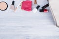 A set of women`s accessories, items and cosmetics for applying makeup, which lie next to a white handbag, a place for your Royalty Free Stock Photo