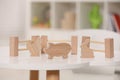 Set of wooden animals and fence on white table indoors. Educational toy for motor skills development Royalty Free Stock Photo