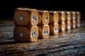 A set of wooden dice placed on a wooden table, suitable for game night or as a decorative piece Royalty Free Stock Photo