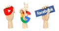 Set of Wooden hands holding YouTube, Google and Facebook logos, on white background. Set with icons and logo of popular social