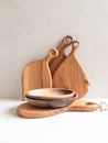 Set of wooden kitchenware - cutting board and bowls. copy space Royalty Free Stock Photo