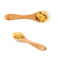 Set of wooden spoon filled with dry conchiglie pasta over isolated white background Royalty Free Stock Photo