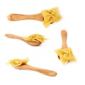 Set of wooden spoon filled with dry farfalle pasta over isolated white background Royalty Free Stock Photo