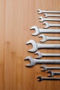 A set of working tools, different size wrenches on a brown wooden, bamboo background Royalty Free Stock Photo