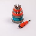 A set of working tools with a screwdriver and bits for repair  in an open plastic box with iron bits Royalty Free Stock Photo