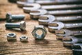 Set of wrenches bolts and nuts on wooden background Royalty Free Stock Photo