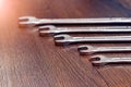 Set of wrenches on a wooden table. Wrenches of different sizes Royalty Free Stock Photo
