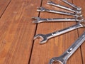 Set of wrenchs chrome metal spanner instruments on wooden surface Royalty Free Stock Photo