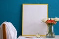 A set for writing, a bouquet of roses in a vase and a yellow large frame for a picture on a blue background Royalty Free Stock Photo