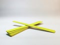 Set of yellow disposable nail files on a gray gradient background