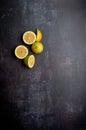 yellow and green lemons, cut and uncut, on a background of dark, black, cement, metallic, marble and stone Royalty Free Stock Photo