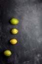 yellow and green lemons on a dark, black, cement, metallic, marble and stone background Royalty Free Stock Photo