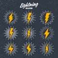 Set of yellow vintage lightning bolts and sunrays on grunge background. Lightnings with sunburst effect. Thunderbolt Royalty Free Stock Photo