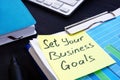 Set your business goals. Stack of financial documents.