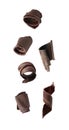 Set with yummy chocolate curls falling on background Royalty Free Stock Photo