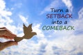 Setback or comeback symbol. Man hand holding wooden bird on cloud sky background. Words `turn a setback into a comeback`. Busine