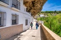Setenil de las Bodegas, Spain - April 6, 2023: Typical Andalucian village with white houses and sreets with dwellings built into