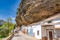 Setenil de las Bodegas, Spain - April 6, 2023: Typical Andalucian village with white houses and sreets with dwellings built into
