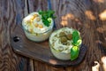 Seth classic appetizer hummus with olives and a basil branch of chickpea, tahini, olive oil, and oriental spices in a bowl on a Royalty Free Stock Photo