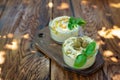 Seth classic appetizer hummus with olives and a basil branch of chickpea, tahini, olive oil, and oriental spices in a bowl on a Royalty Free Stock Photo