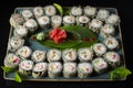 Seth sushi on a black background.Menu of the Japanese restaurant. Several sushi laid out on a plate with ginger sauce wasabi. Royalty Free Stock Photo