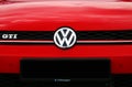 Volkswagen motor company emblem on red car. Volkswagen Group is a German automo